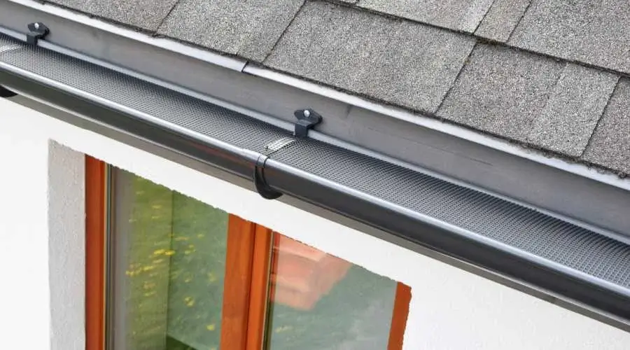 A gutter guard on a roof line