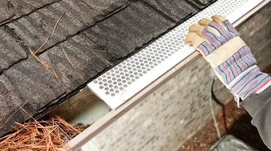 A gutter guard with debris still in part of it