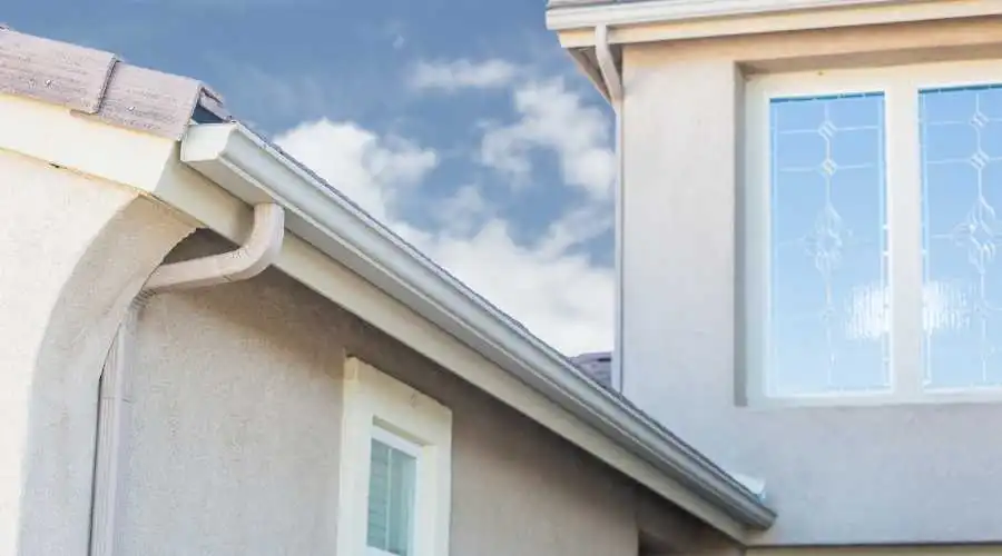 A seamless gutter on a cream colored house