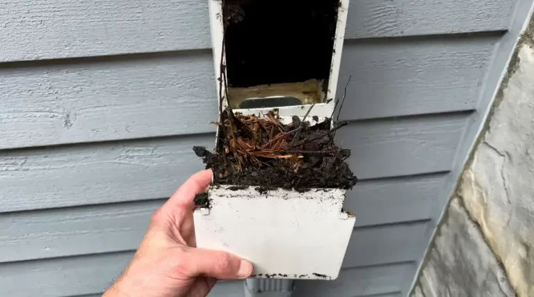 person removing gutter filter filled with dirty debris